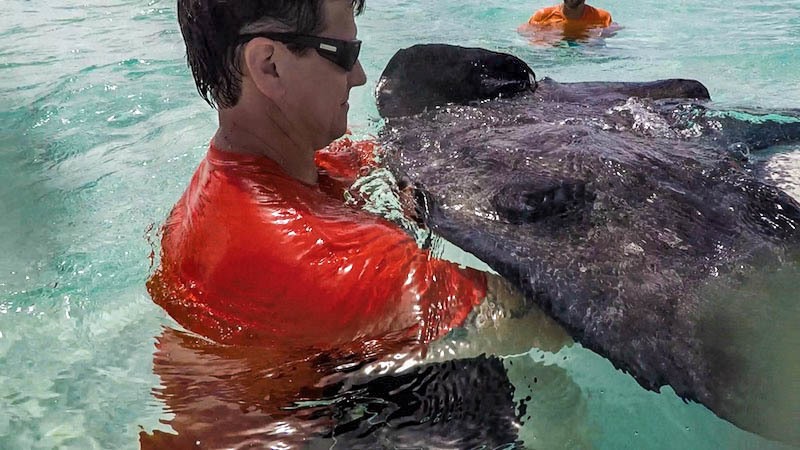 Keith Holding Ray in Stingray City Grand Cayman - Crazy Crab